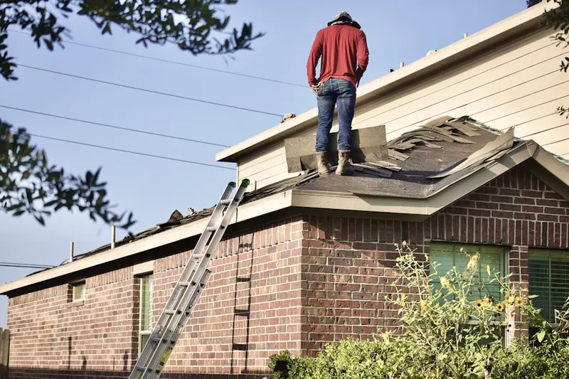 Professional roofer working on a residential roof in Trail Lake